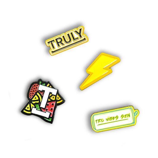 A set of four colorful Truly Hard Seltzer themed enamel pins: a yellow rectangular pin with "TRULY", a yellow lightning bolt, a pin with fruit and a "T", and a yellow can pin with "TRU VIBES SZN".