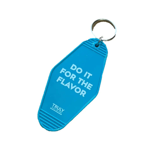A light blue key fob with a metal ring at the top, featuring "DO IT FOR THE FLAVOR" in white text and a small "TRULY HARD SELTZER" logo at the bottom.