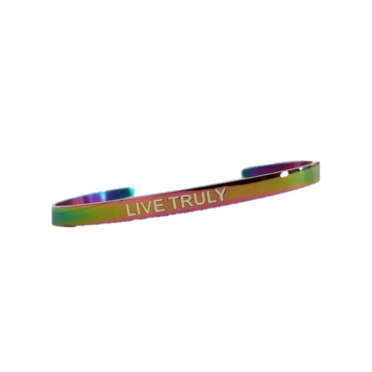 A close-up view of a rainbow-colored galvanized bracelet with "LIVE TRULY" engraved in the center.