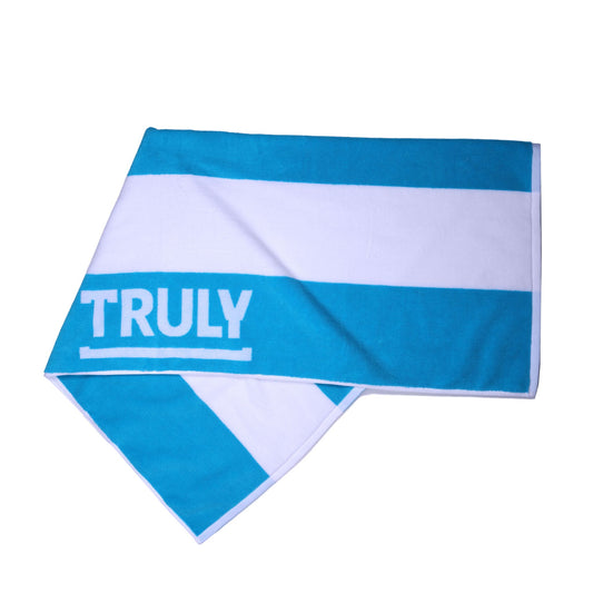A folded blue and white striped towel with the word "TRULY" printed across the blue stripe.
