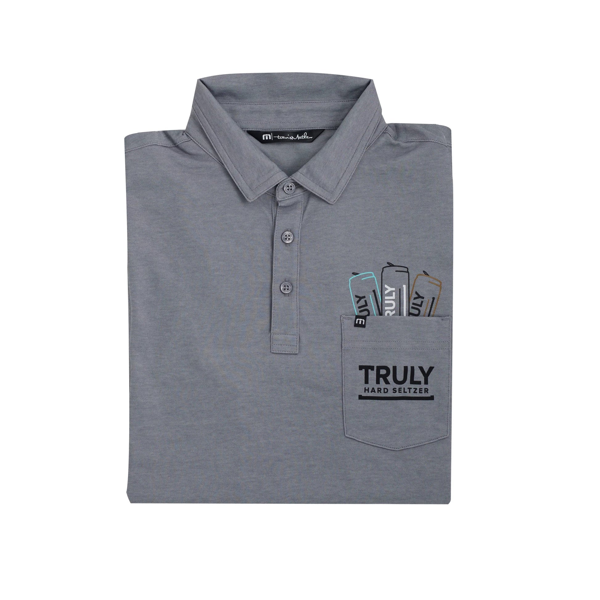 A grey short-sleeved polo shirt, folded neatly, with the collar visible at the top. The shirt features a pocket on the left chest with three partially visible slim cans embroidered inside, each labeled 'TRULY'. Below the cans, the pocket is printed with the word 'TRULY' in large black letters and 'HARD SELTZER' in smaller black letters.