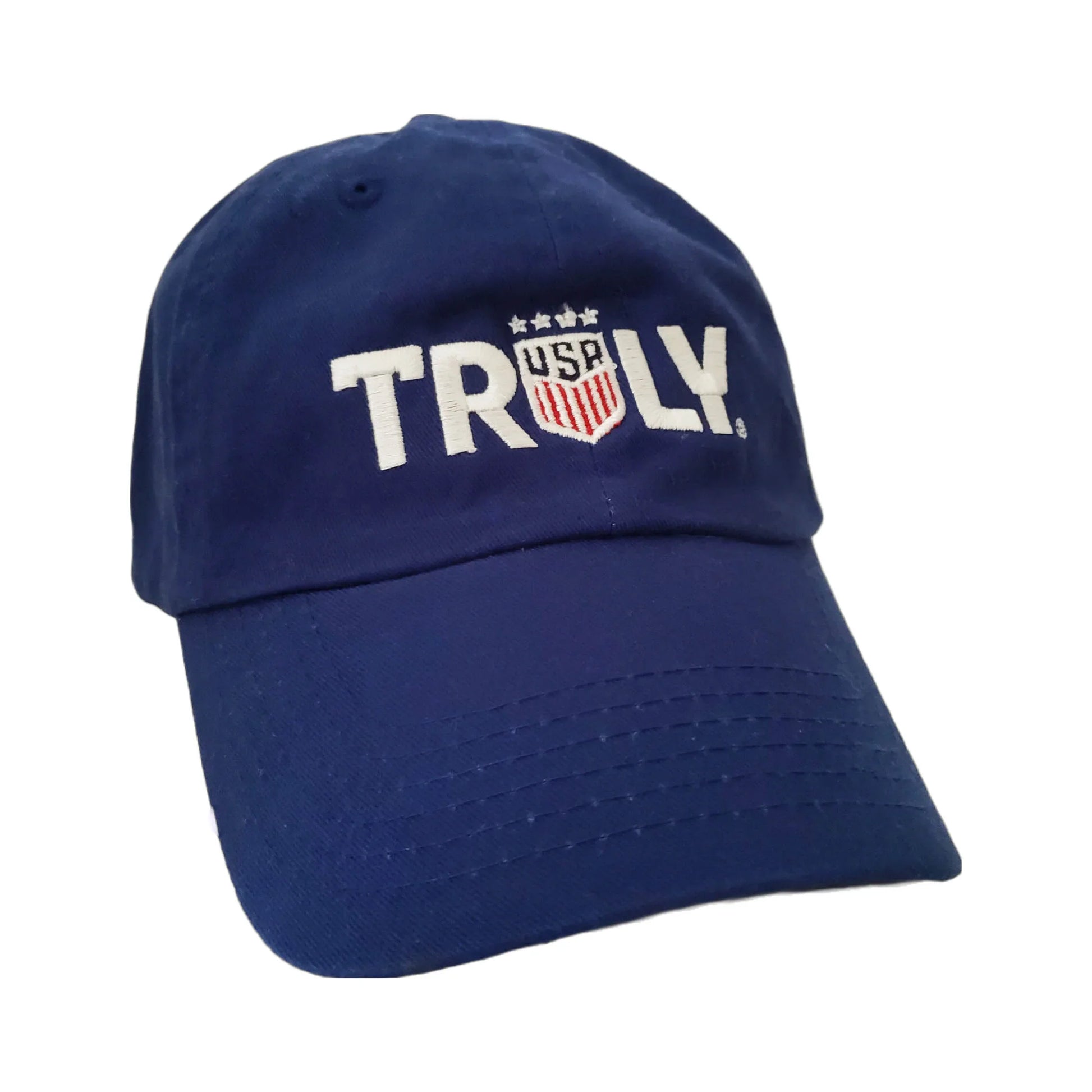 A royal blue baseball cap with the word 'TRULY' embroidered in large white letters across the front. The 'U' in 'TRULY' is replaced by a red, white, and blue shield logo with 'USA' and three stars above it, resembling the U.S. Soccer Federation crest.