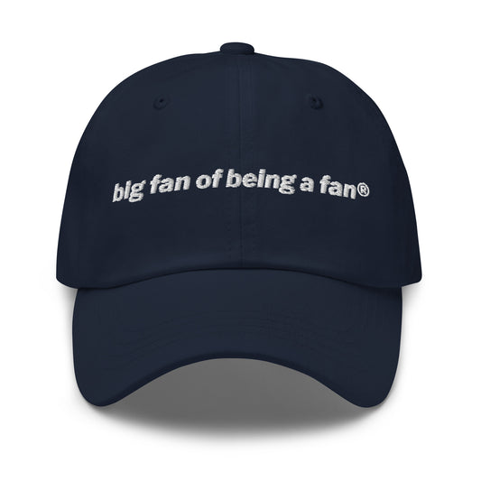 Navy cap with 'big fan of being a fan' text on a white background